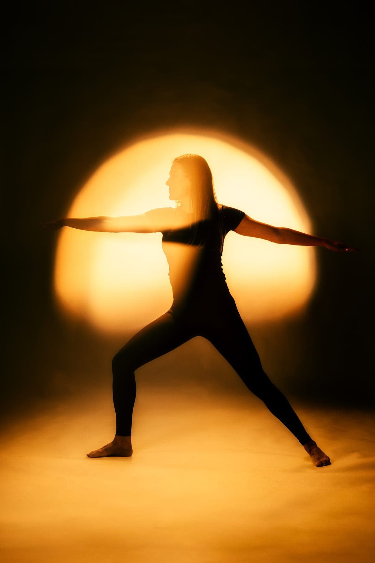 A figure in a warrior pose within a radiant field of light — Igniton's ‘Born from Light’ motif